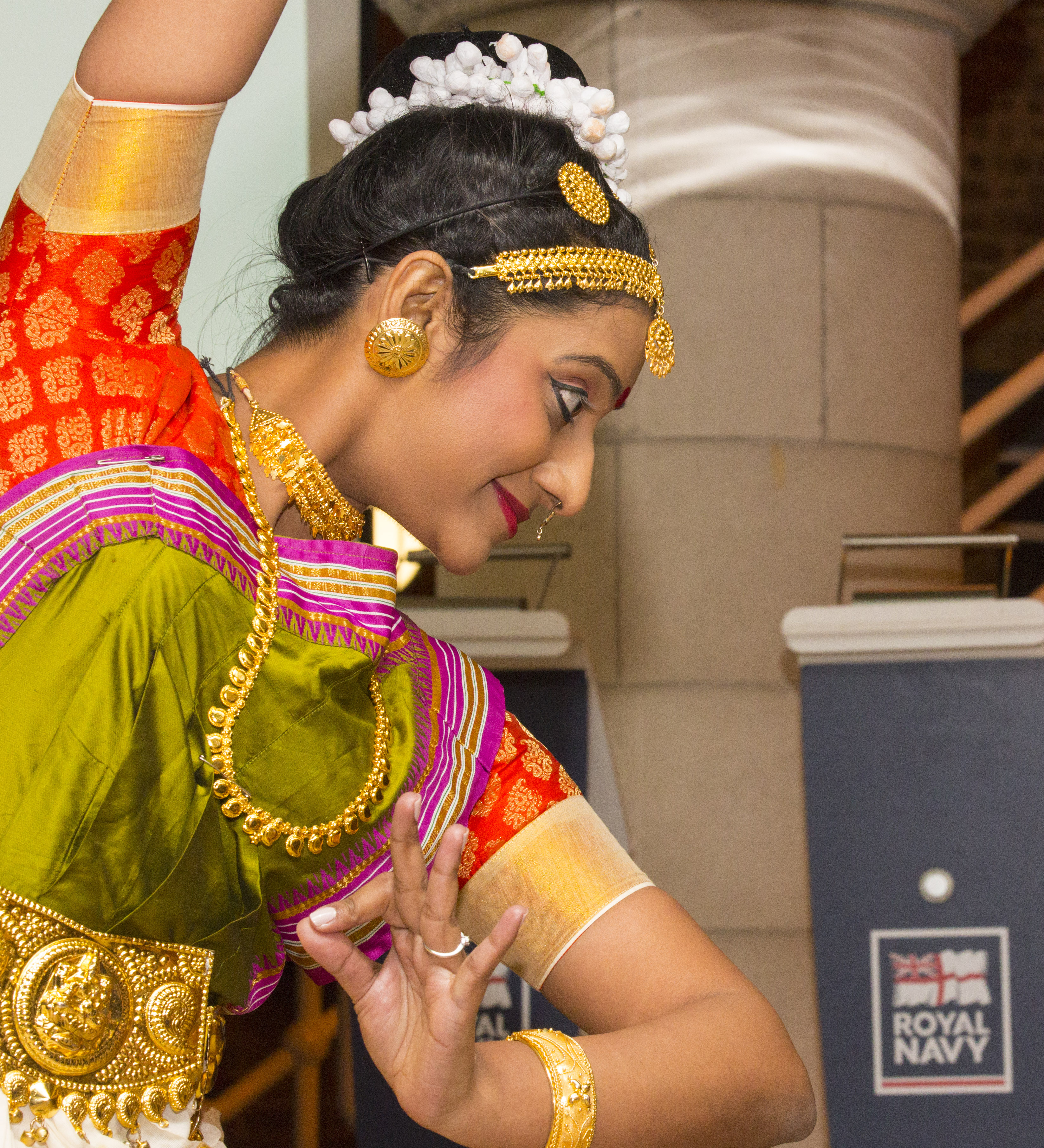 An Indian woman dancing in traditional clothing. 
