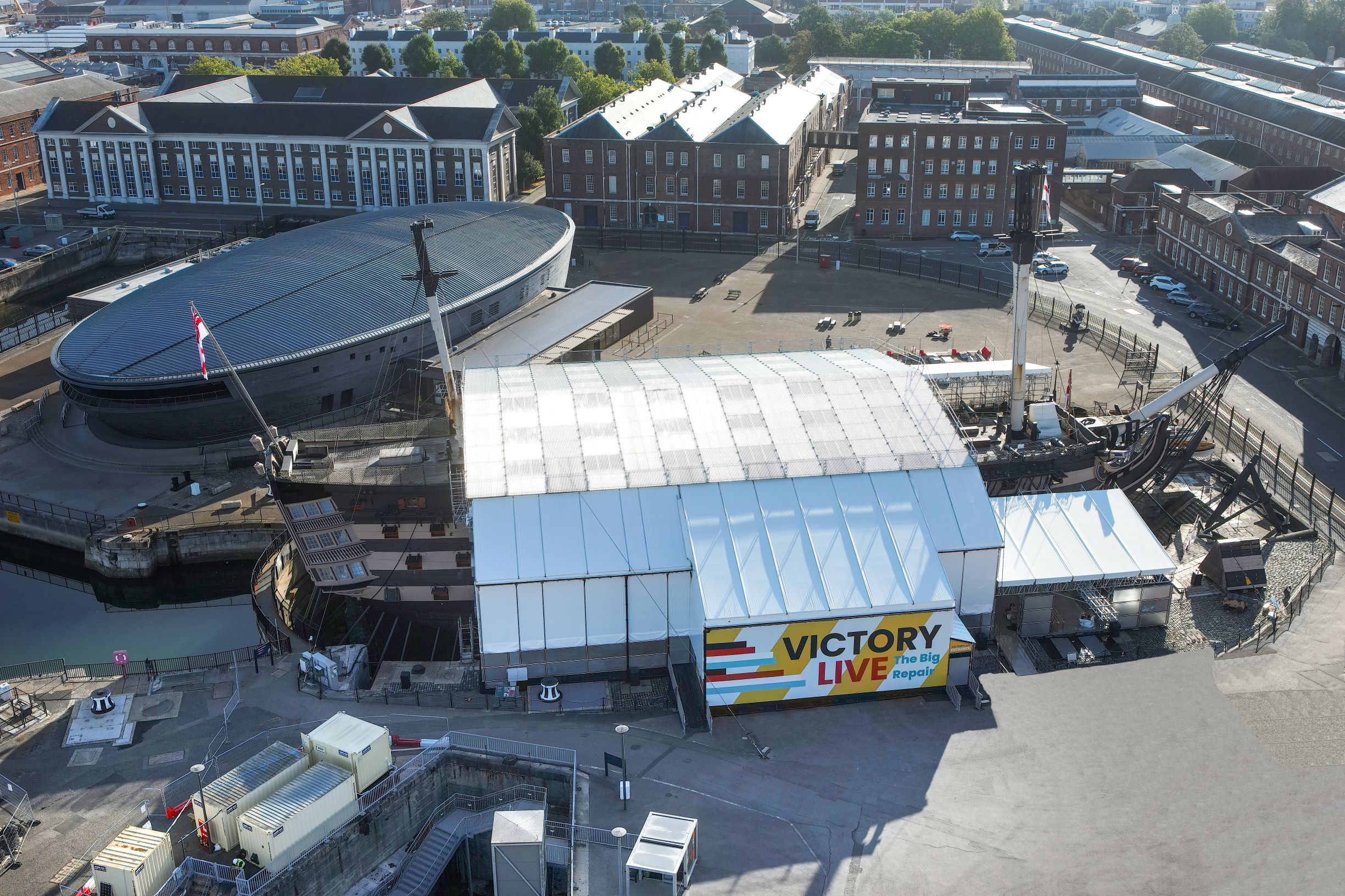 Drone view of HMS Victory covered in the protective scaffolding of Victory Live. 
