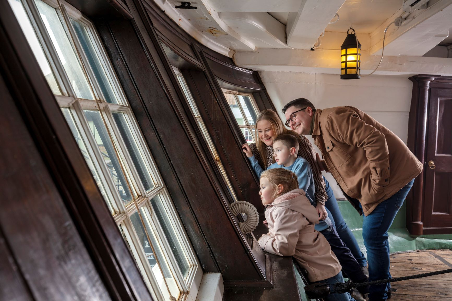 A family explore the inside HMS Trincomalee.
