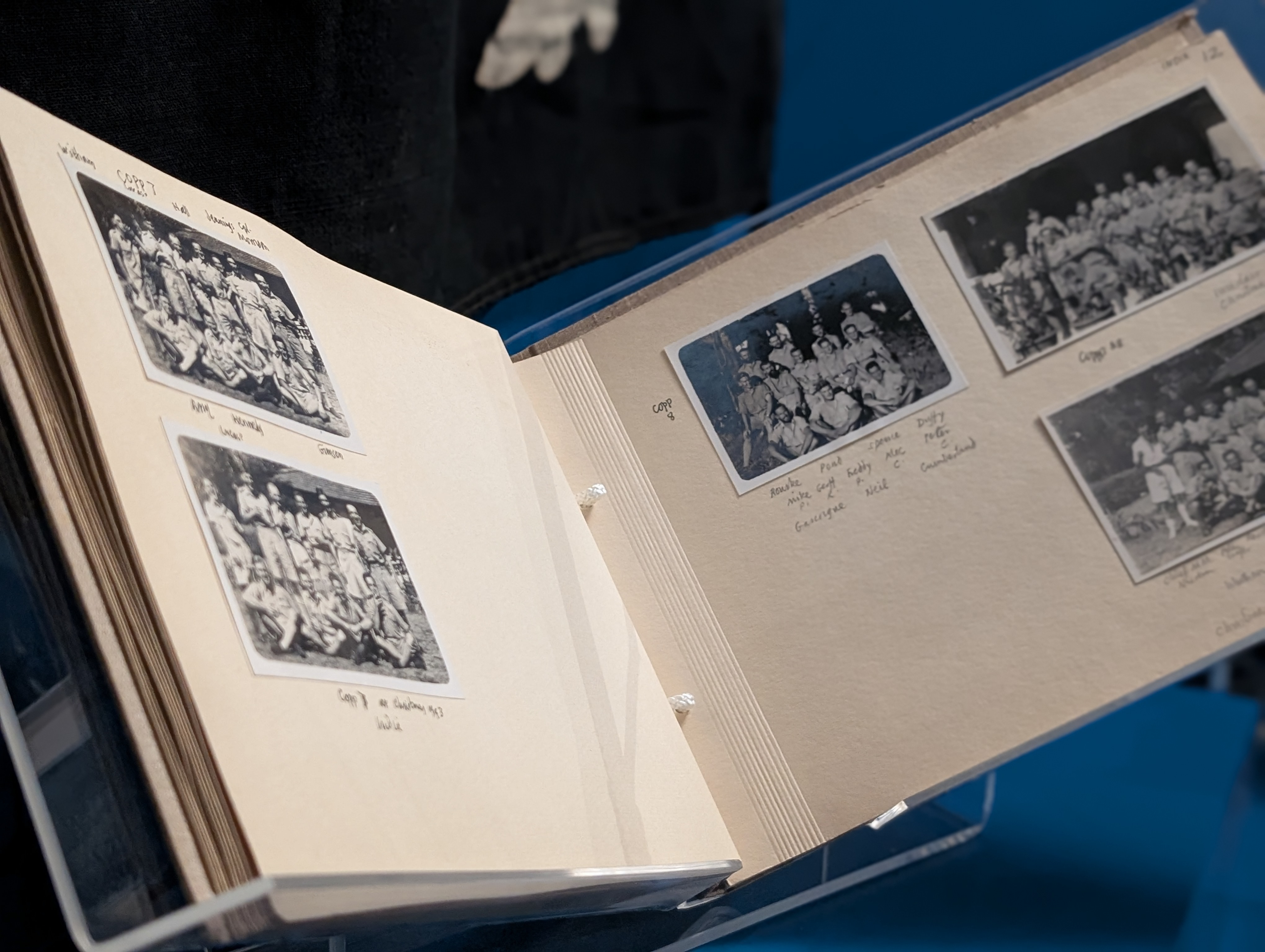 A close-up on a photo album featuring various black and white photos