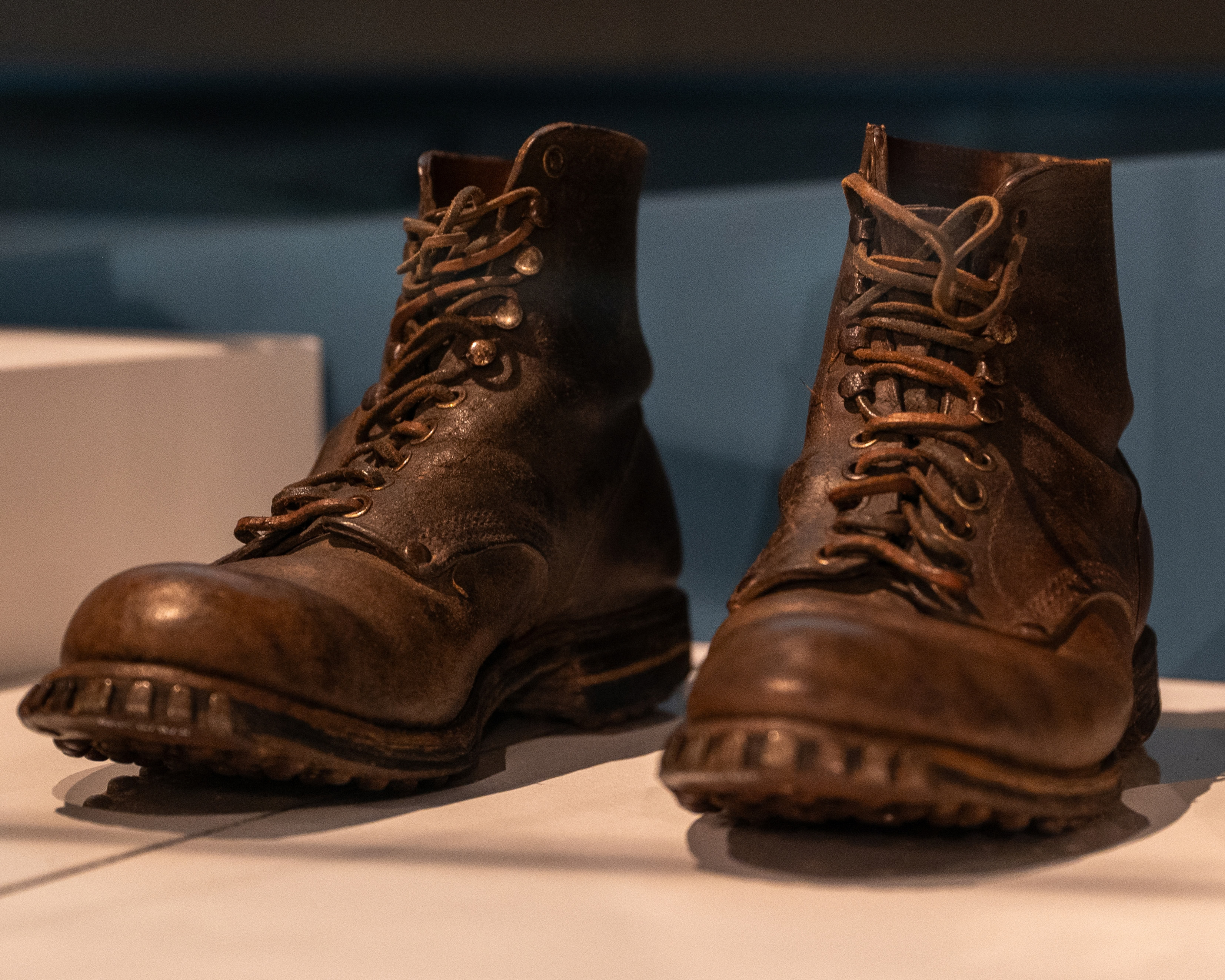 Worn leather boots belonging to Bill Sparks on display in a museum case