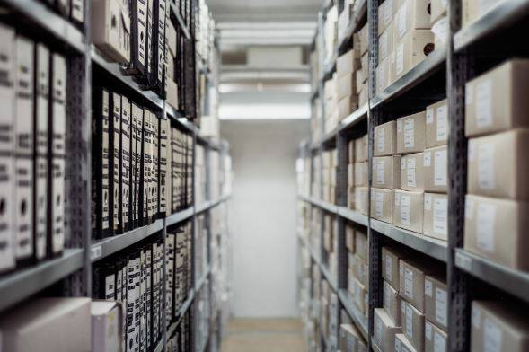 Our collection archive shelves full of boxes of documents. 