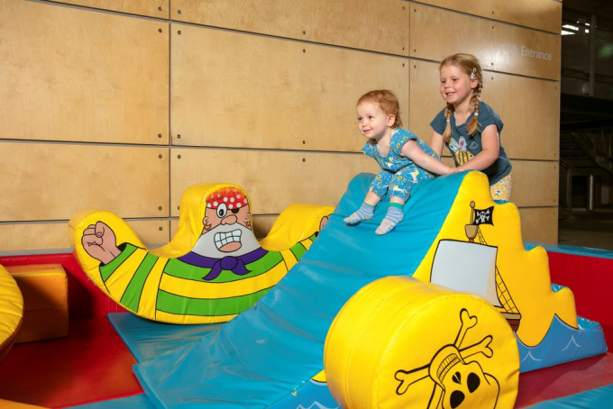 Children in a small softplay area.