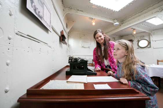 Mother and daughter next to the captain's desk aboard HMS Caroline.
