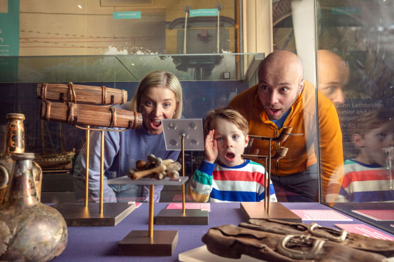 Family look at artefacts from the HMS Invincible 1744 salvage site. 