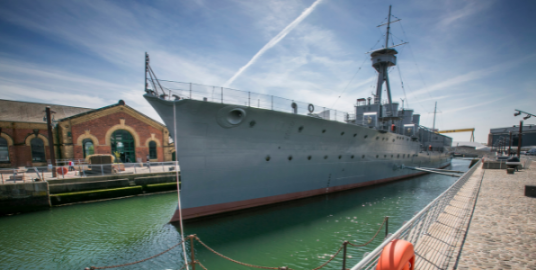 HMS Caroline at birth in Belfast on a sunny day. 
