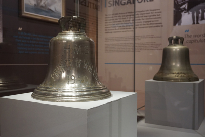 HMS Prince of Wales's ship bell in a display case. 