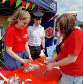 National Museum of the Royal Navy volunteers and Royal Naval personnel volunteering at a Pride stall. 