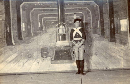 A stage replicating the inside of a naval ship with a female actor dressed as a Royal Marine. 
