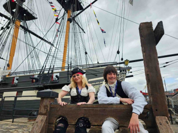 Two pirates sit in the stocks in front of HMS Trincomalee at Hartlepool. 