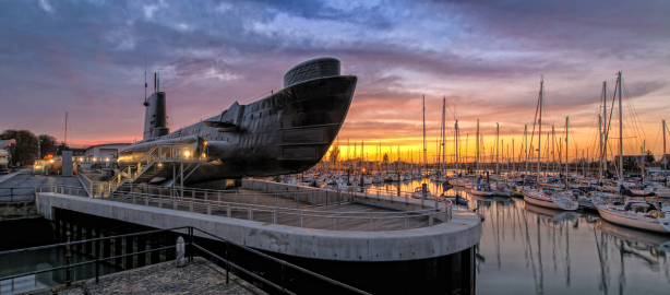 HMS Alliance sits in dock at Gosport harbour at sunset.