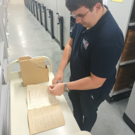 A conservator looking at a book in our collection. 
