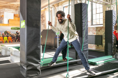 A father climbing the obstacle course at Action Stations.