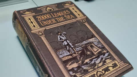 A book of 20,000 Leagues Under the Sea with an illustrated cover showing Captain Nemo. 