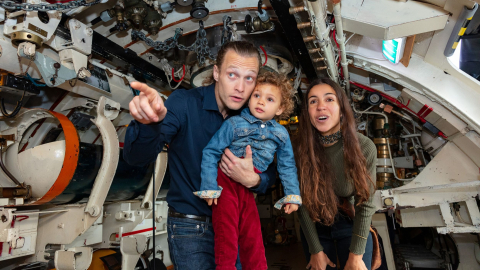 A family having fun onboard HMS Alliance. 