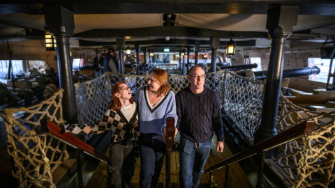 Mother, father, and teenage daughter enjoying a visit to HMS Victory. 