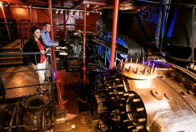 A couple look at HMS Caroline's engine room.