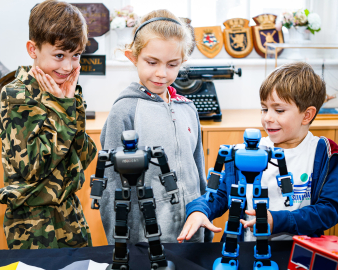 Children having fun with some toy-sized robots. 
