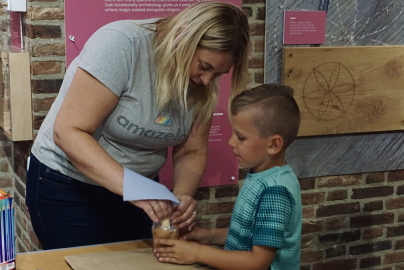 Instructor and child working on project together.