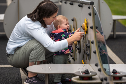 mother and child taking part in activity on toy plane