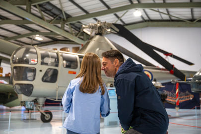 father and daughter looking at helicopter and discussing