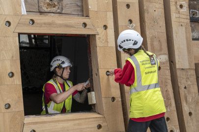 Two shipwrights working on Gunport of HMS Victory Renovation