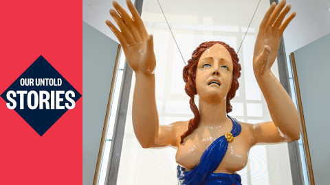 Figurehead statue of a woman with red hair and a blue dress