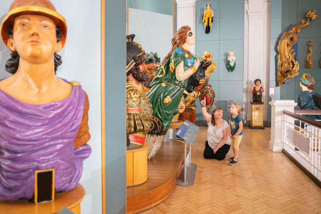 A collection of the colourful figureheads on display in the Victory Gallery.  