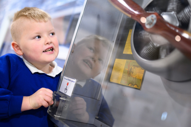 School child looking at a propeller from the Fleet Air Arm Museum. 