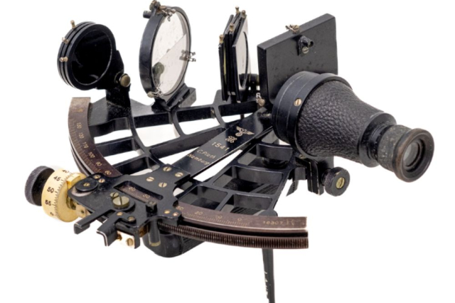 A sextant against a white background. 