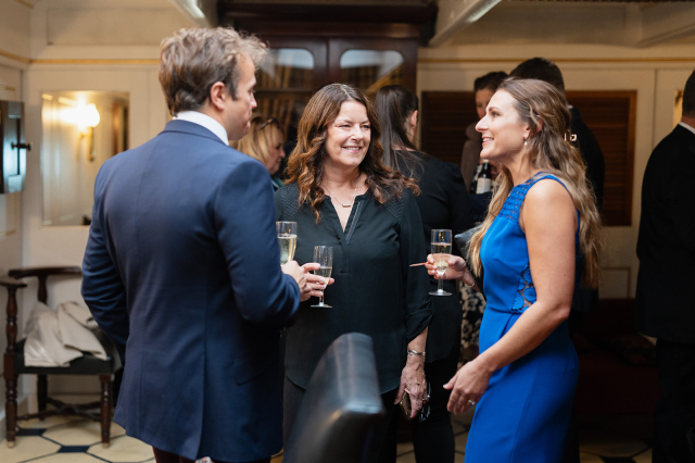 Business people networking onboard HMS Warrior.