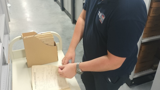 A conservator looking at a book in our collection. 