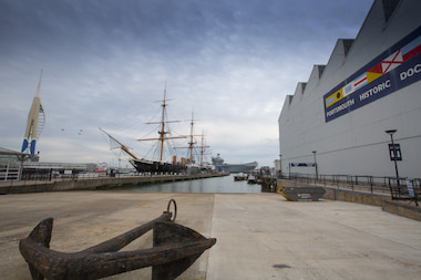 HMS Warrior docked next to Boathouse 4 in Portsmouth Historic Dockyard.