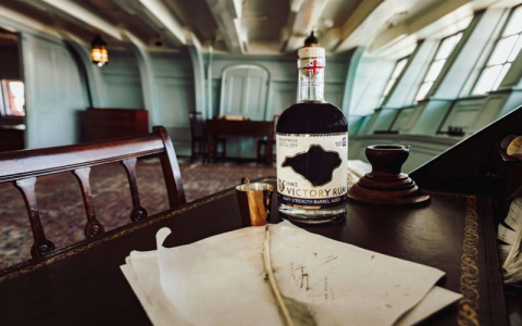 Victory Rum bottle on the desk in Nelson's cabin.