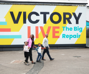 A family walk past Victory Live on their way to learn about her restoration. 