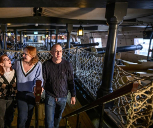 Mother, father, and teenage daughter enjoying a visit to HMS Victory. 