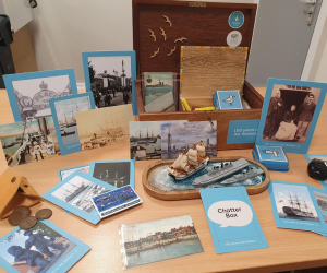 A box full of nautical items open on a table. 