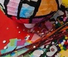 Craft materials including a decorated paper lantern, pipe cleaners, and pom-poms