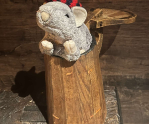 Plush toy rat wearing a knitted red and black striped hat, part of the 'Rats in Hats' event
