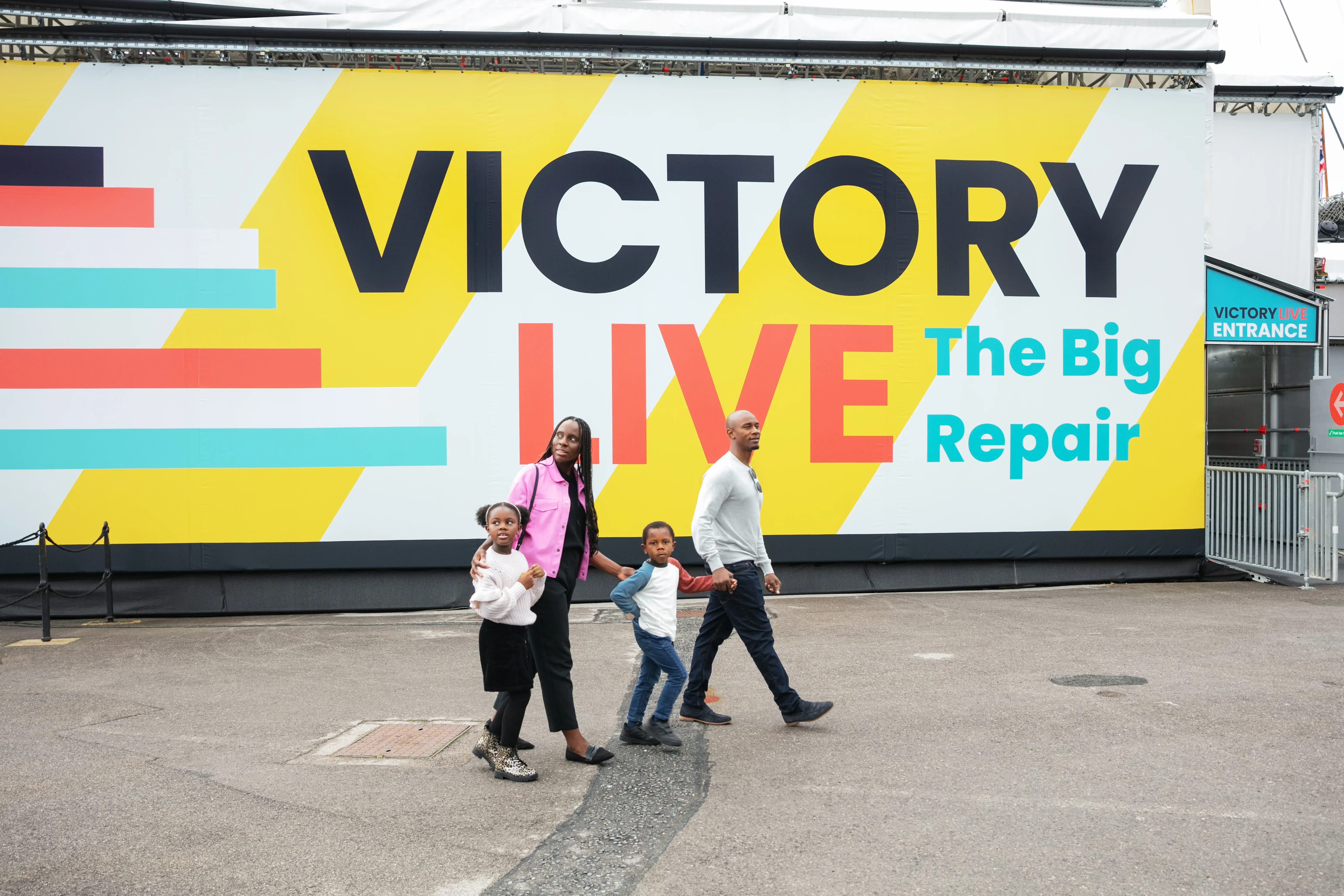 A family walk past Victory Live on their way to learn about her restoration. 